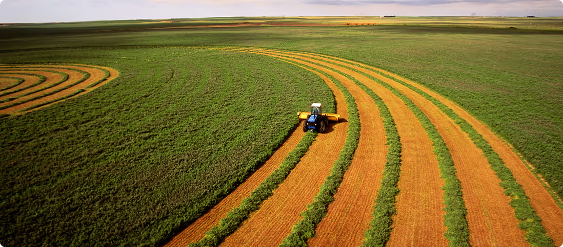 Aerial view of a tractor harvesting a paddock