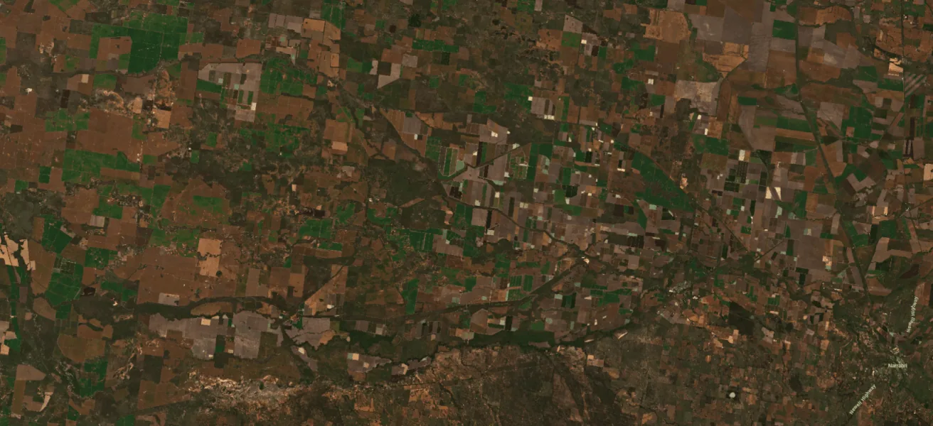 Animated satellite comparison highlighting flood extent across agricultural land